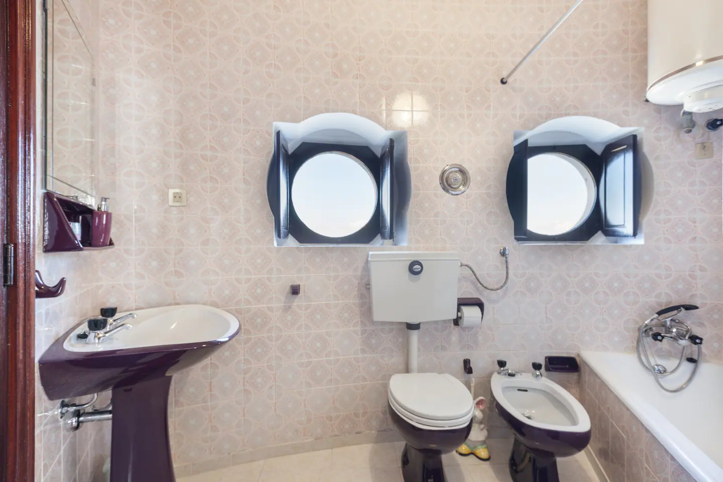 Bathroom with bath, bidet and round windows