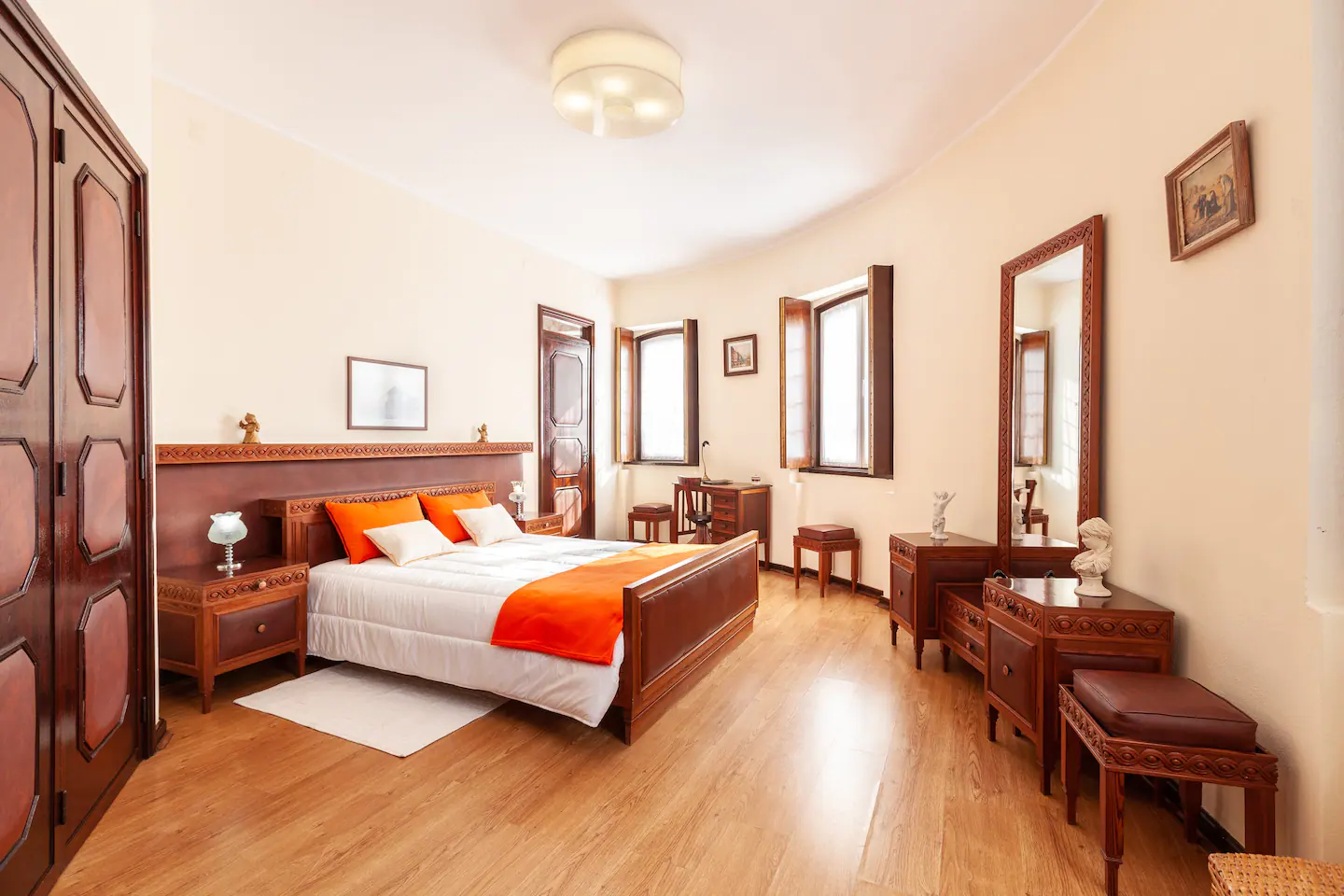 Spacious double bedroom with warm orange accents