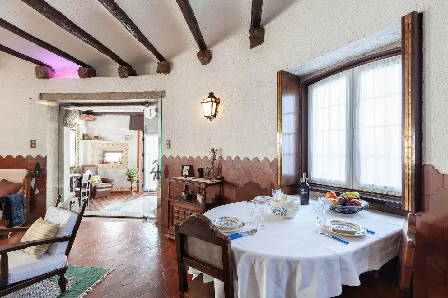 Dining room prepared for a meal beside the living area