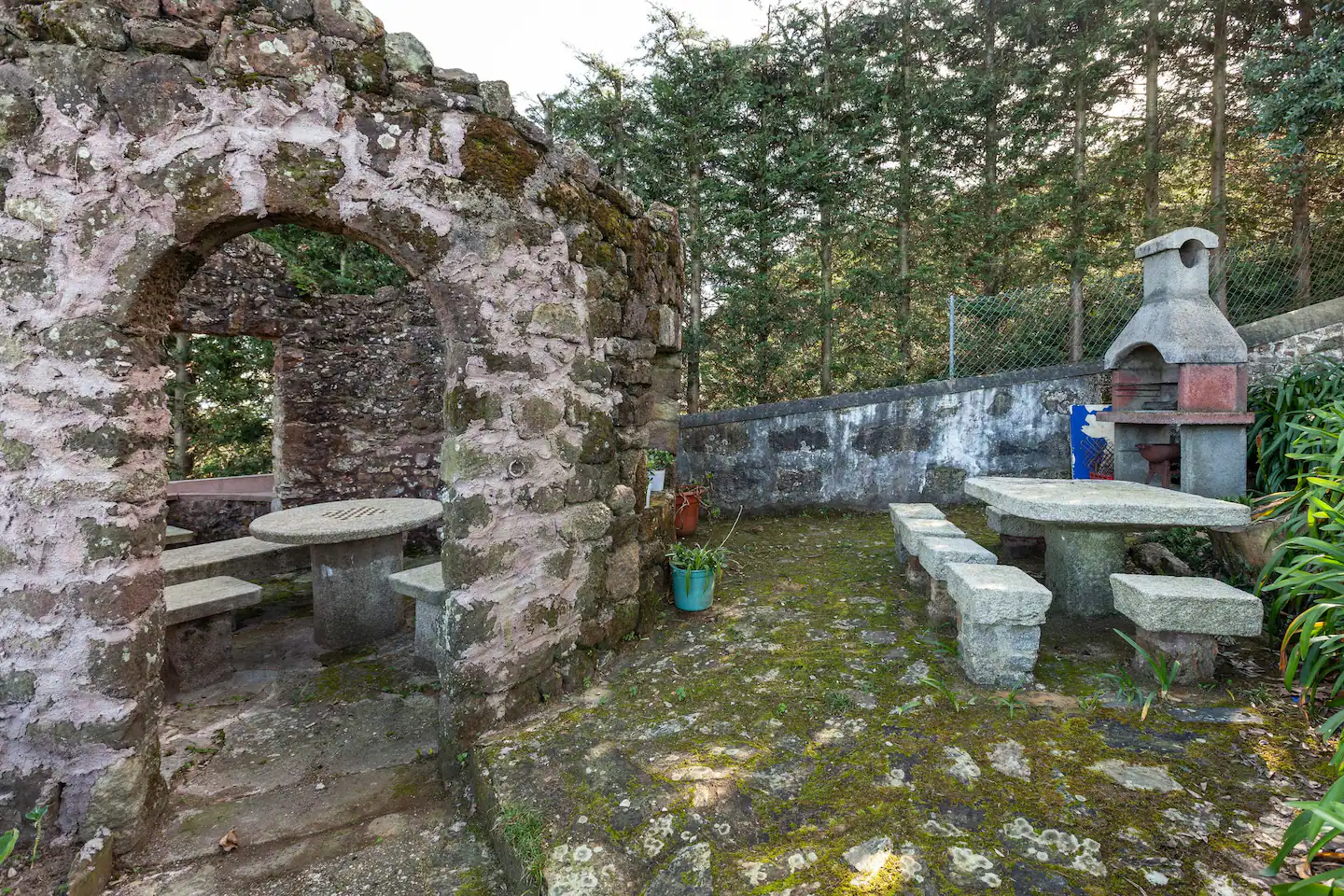 Private garden with stone barbecue and outdoor seating