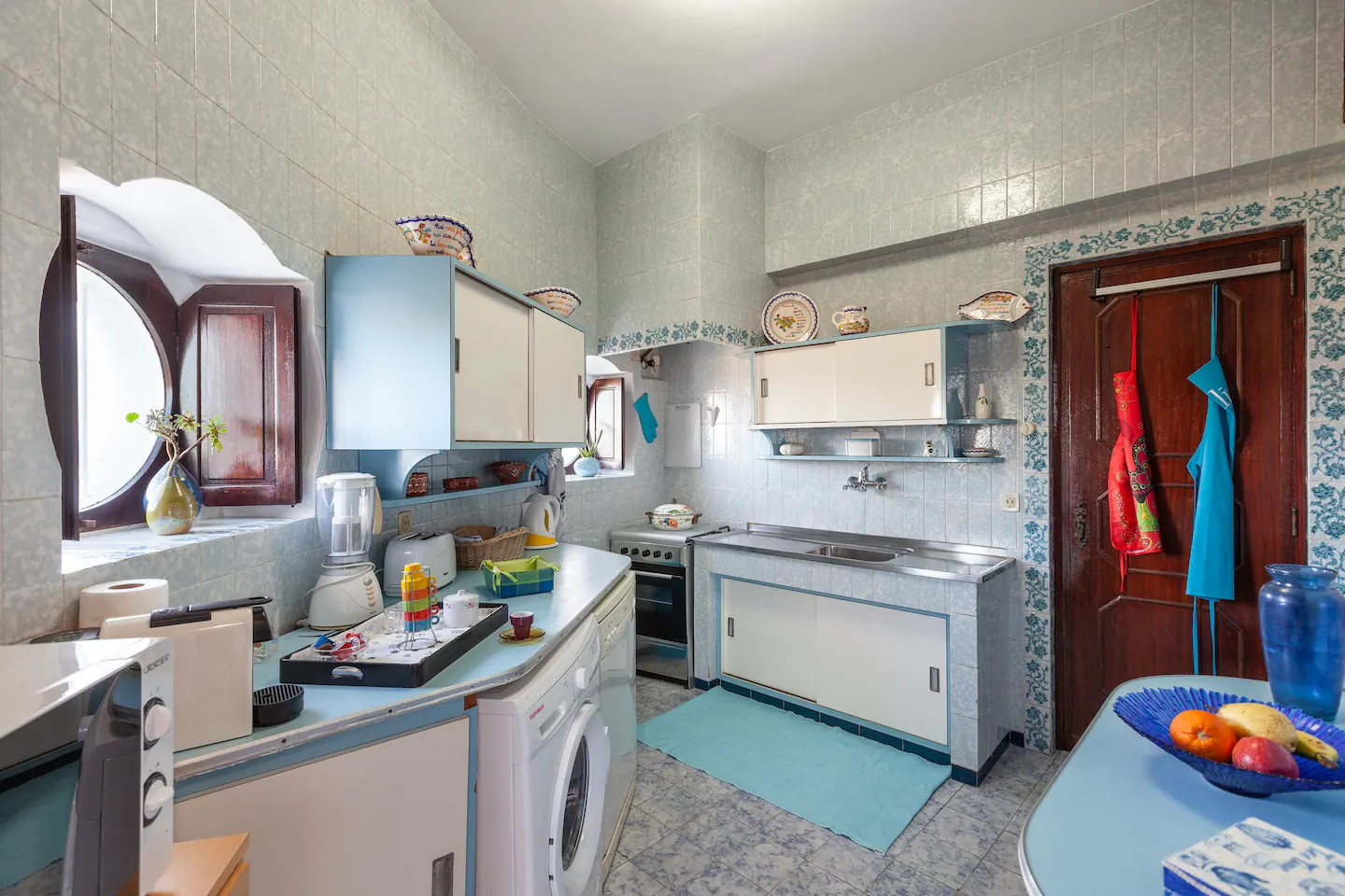 Wide view of the kitchen with original round window