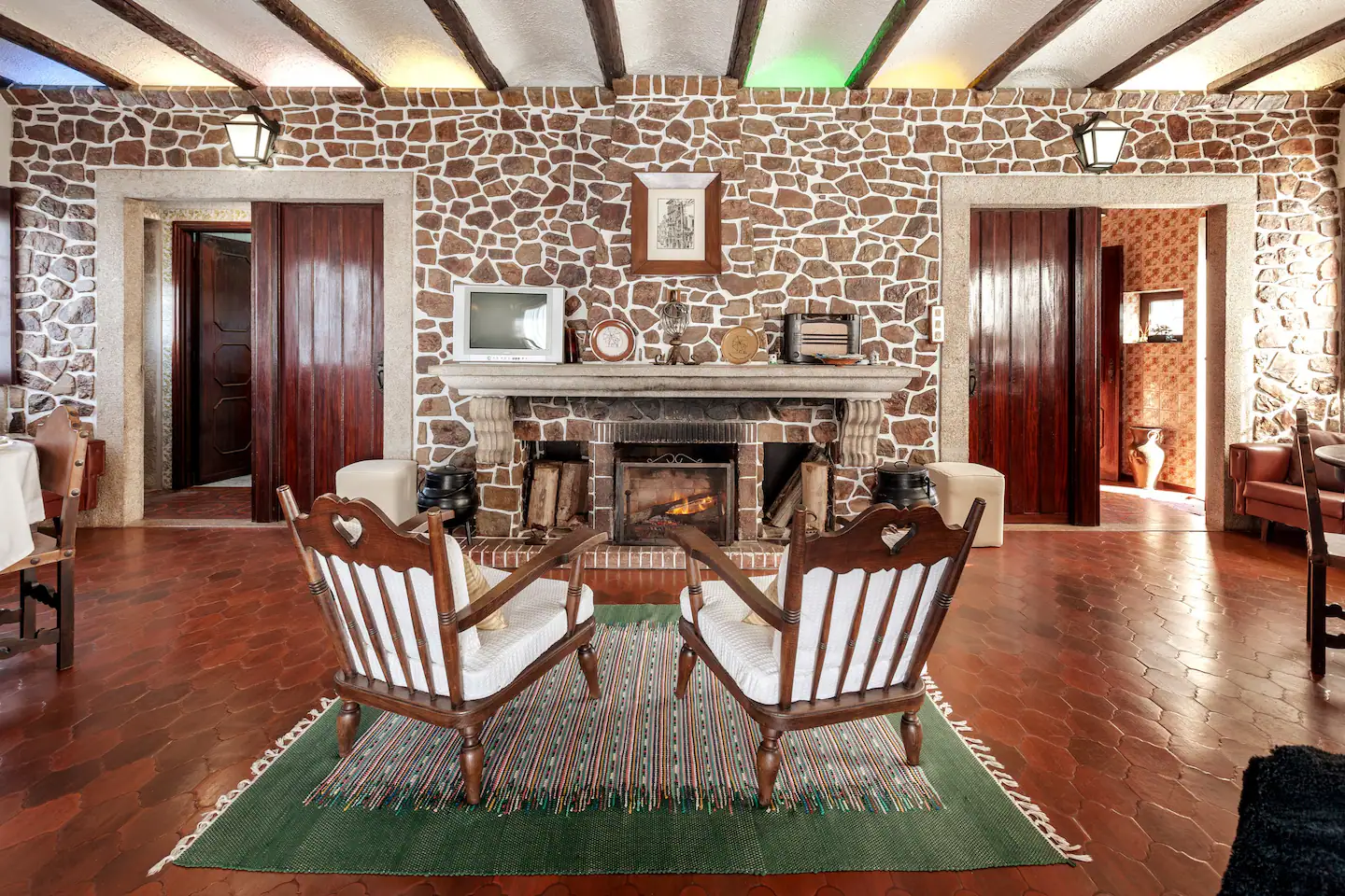 Main living room with original stone fireplace and timber beams