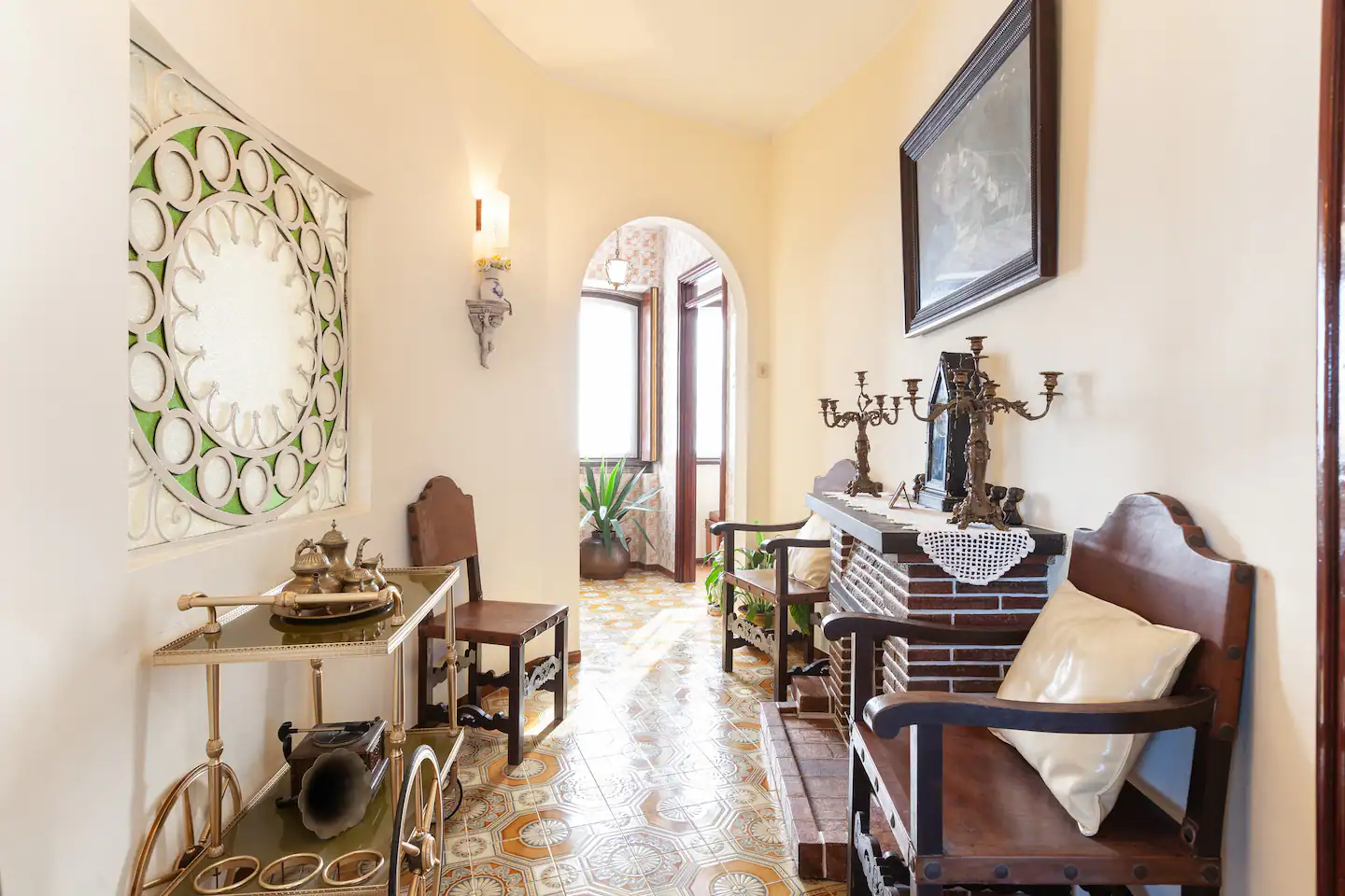Upper hallway with antique furniture and arched doorway