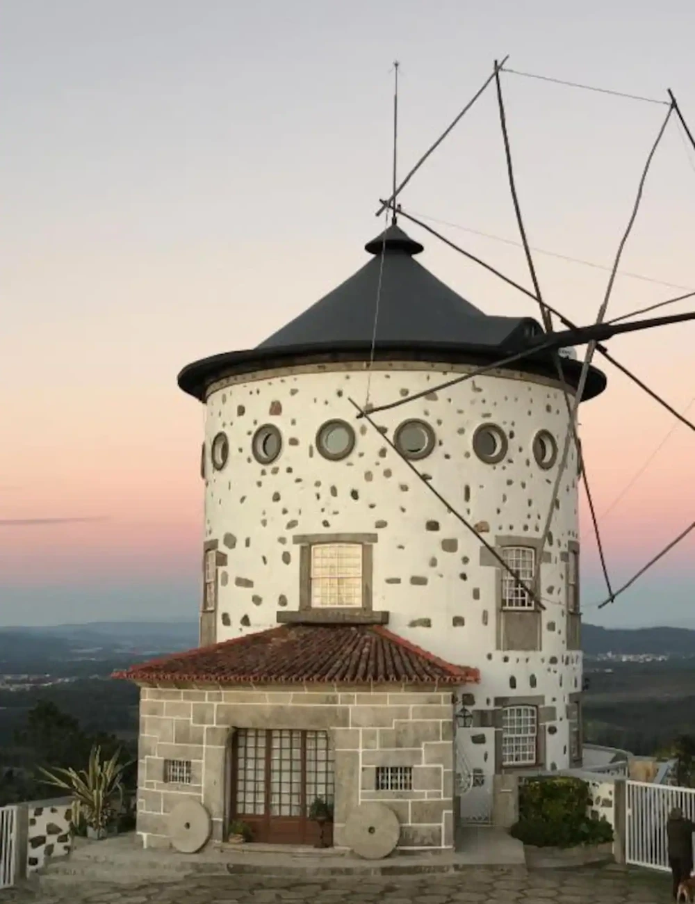 The distinctive circular Moinho House windmill at dusk